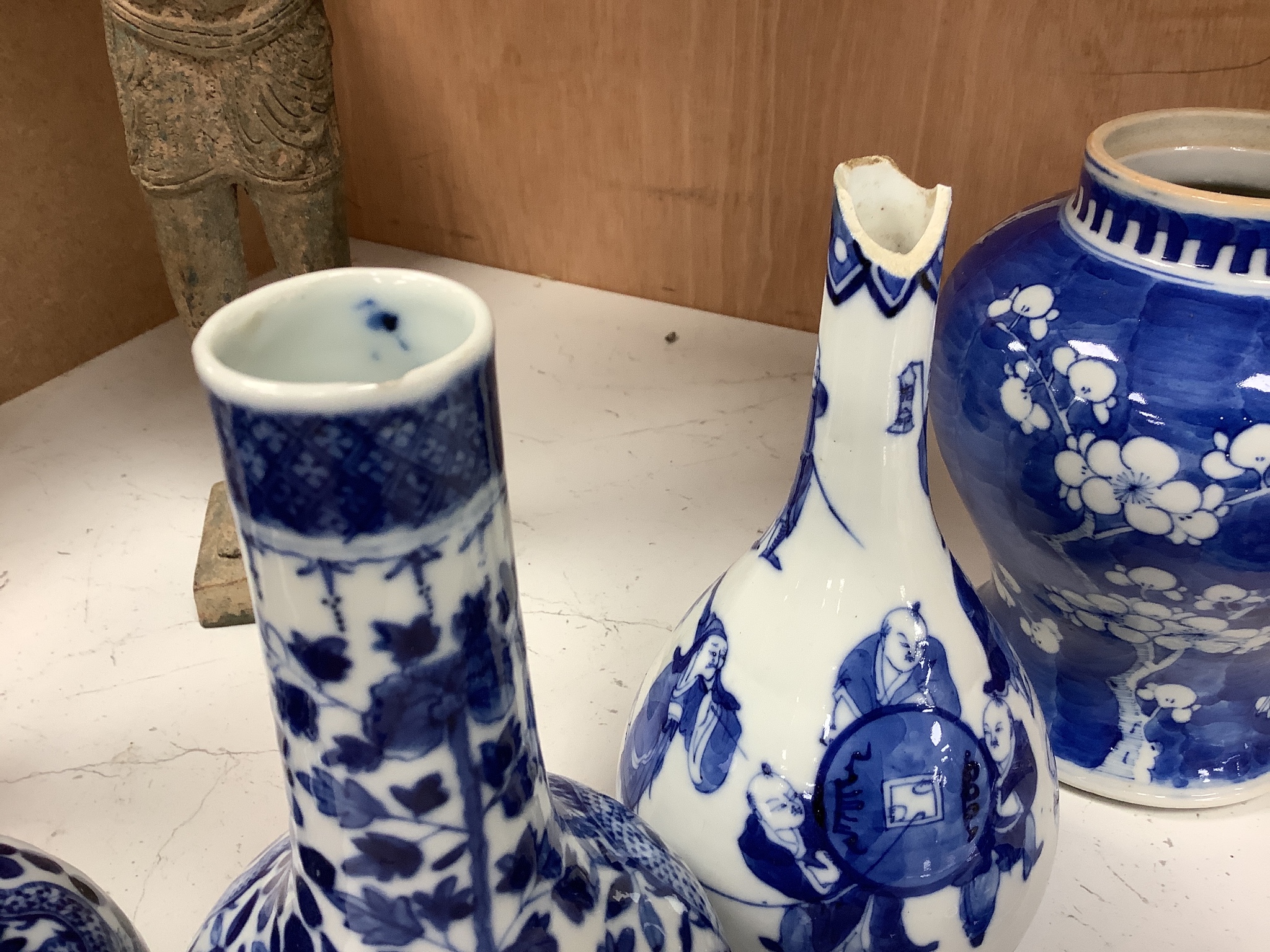 A pair of Chinese blue and white 'dragon' bottle vases, a prunus jar and cover, all late 19th century